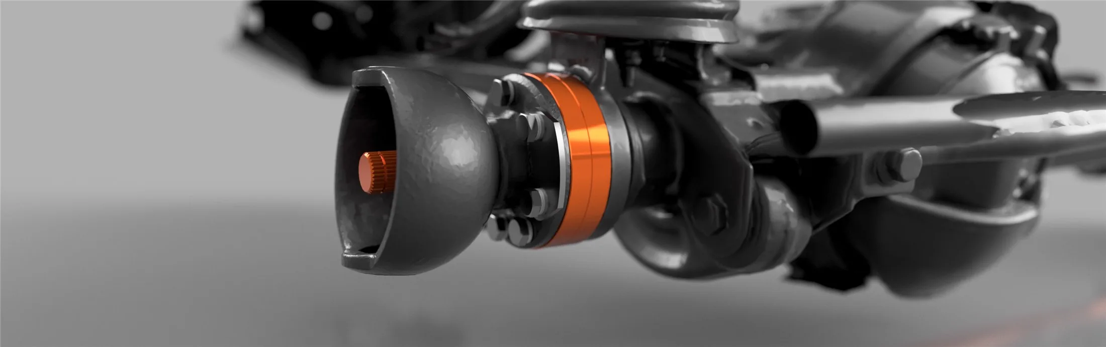 Close-up of the front axle: the two orange widening rings sit between the axle and the swivel ball